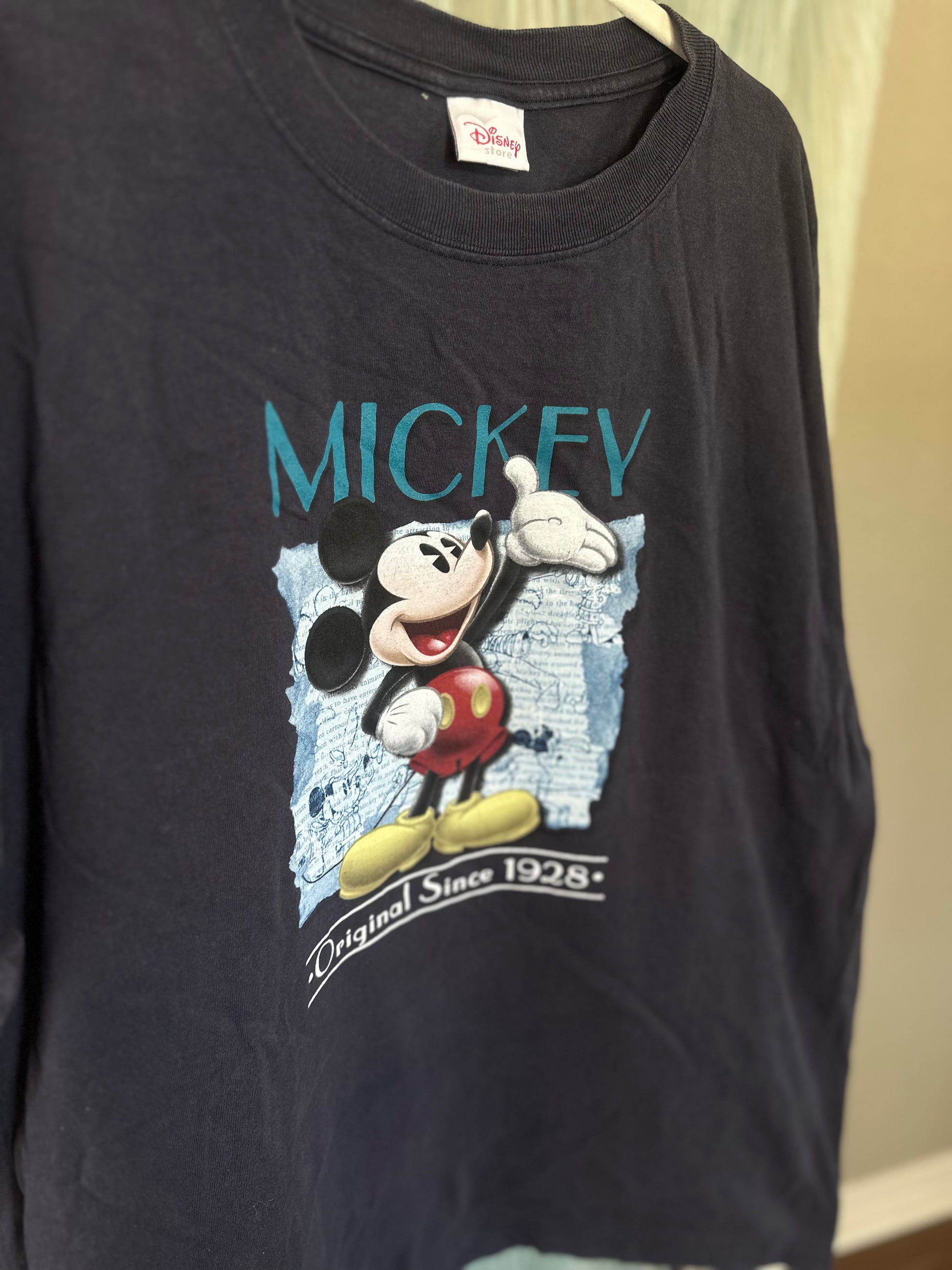 A vintage Mickey Mouse long-sleeve t-shirt in black, featuring a graphic print of Mickey on a blue background with 'MICKEY' and 'Original Since 1928' text.